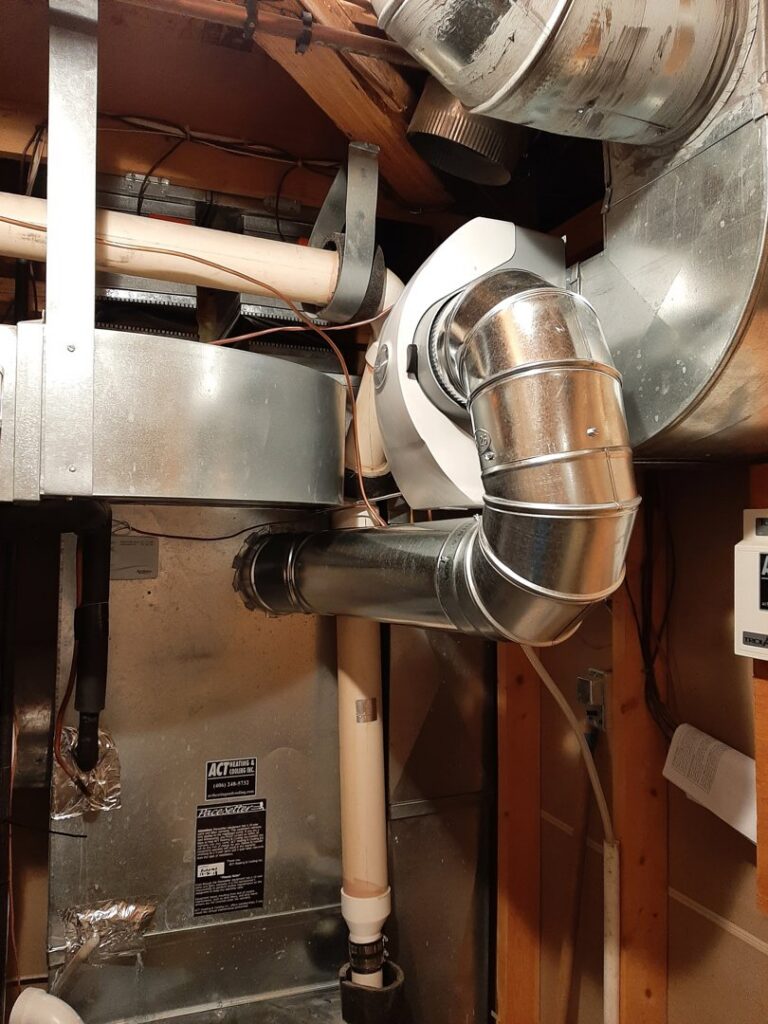 An indoor furnace and air handler unit with connected ductwork, part of an HVAC system by Arrowseal of Billings HVAC in Billings, MT.