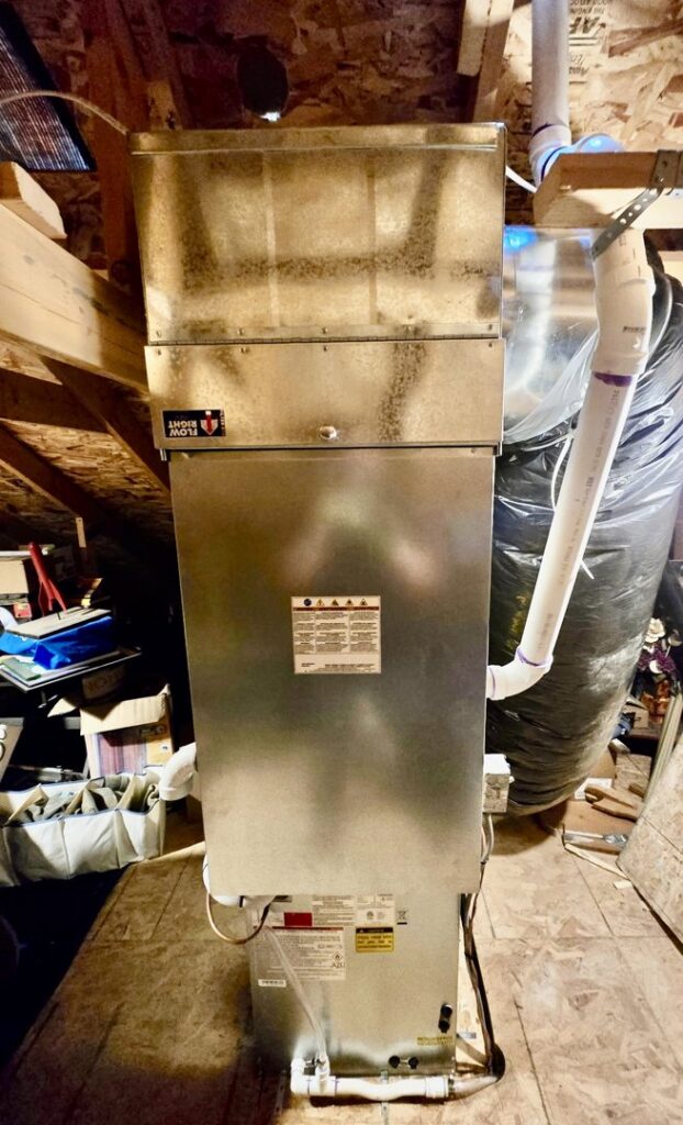 An indoor furnace and air handler unit installed in an attic space by Lee's Heating & Cooling in Pueblo, CO.