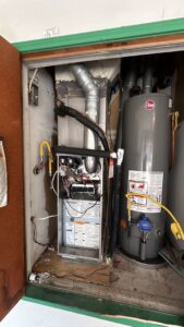 An indoor furnace and air handler unit with ductwork in a utility closet by Bree HVAC Contractor in Cedar Park, TX.