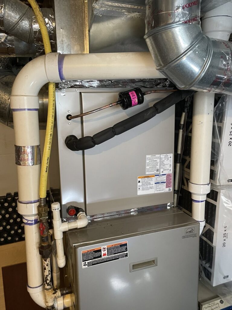 An indoor furnace and air handler unit with ductwork and piping installed by Carpenter Mechanical in Columbus, OH.