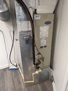 An indoor furnace and air handler unit with ductwork, serviced by ECA DuctWorks in Reston, VA