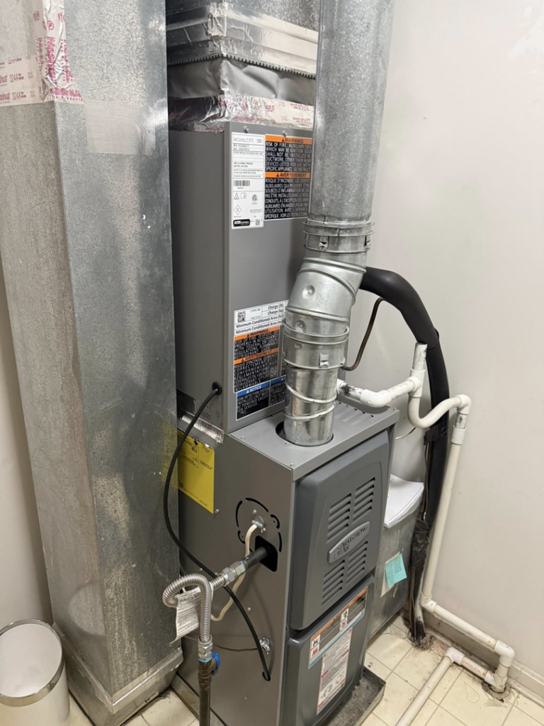An indoor furnace and air handler unit with ductwork, serviced by Lighthouse HVAC, LLC in Edgewater, MD.