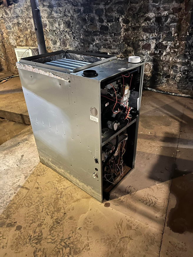 An indoor furnace or air handler unit, serviced by Preston Heating and Air Conditioning in Rochester, NY.
