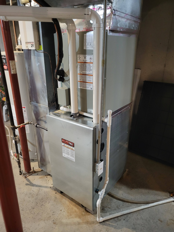 An indoor RunTru furnace and air handler unit installed by ESR Heating, Cooling and Refrigeration in Raymore, MO.