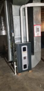 An indoor furnace and air handler unit with ductwork, installed by Steve's Heating & Cooling in Florence, KY.