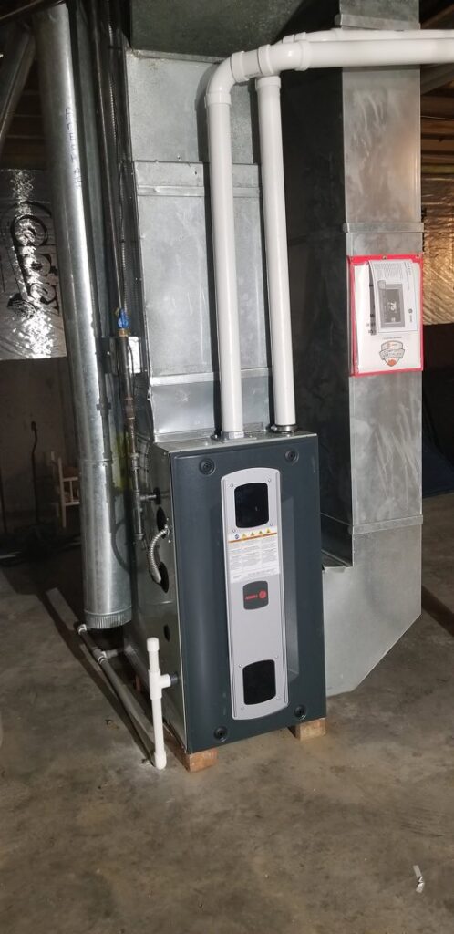 An indoor furnace and air handler unit with ductwork, installed by Steve's Heating & Cooling in Florence, KY.