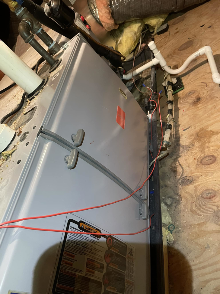 An indoor furnace or air handler unit with visible ductwork, serviced by Viking Mechanical LLC, an HVAC contractor in Rapid City, SD.