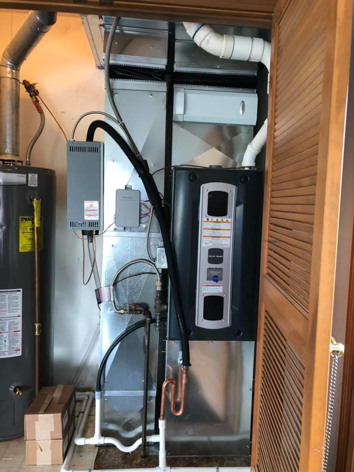 An indoor furnace and air handler unit with a water heater installed by Fellowship Heating and Cooling in Indianapolis, IN.