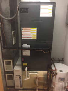 An indoor furnace or air handler unit with ductwork and water heater installed by R&M Mechanical Services LLC in Milford, CT.