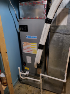 An indoor furnace and air handler unit with ductwork installed by Zibi Construction in Mount Prospect, IL.
