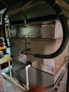 An indoor furnace unit next to a water heater, serviced by Carpenter Mechanical in Columbus, OH.