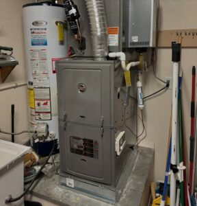 An indoor furnace and water heater installed in a utility closet by Cool Camel HVAC in Henderson, NV