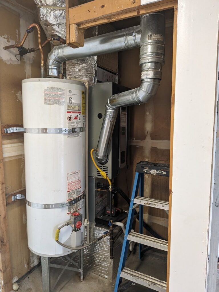 An indoor furnace and water heater system installed by Elevate Heating & Cooling in Hillsboro, OR.