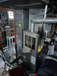 An indoor furnace and ductwork installation in a utility room by Handy Properties LLC in Akron, OH.