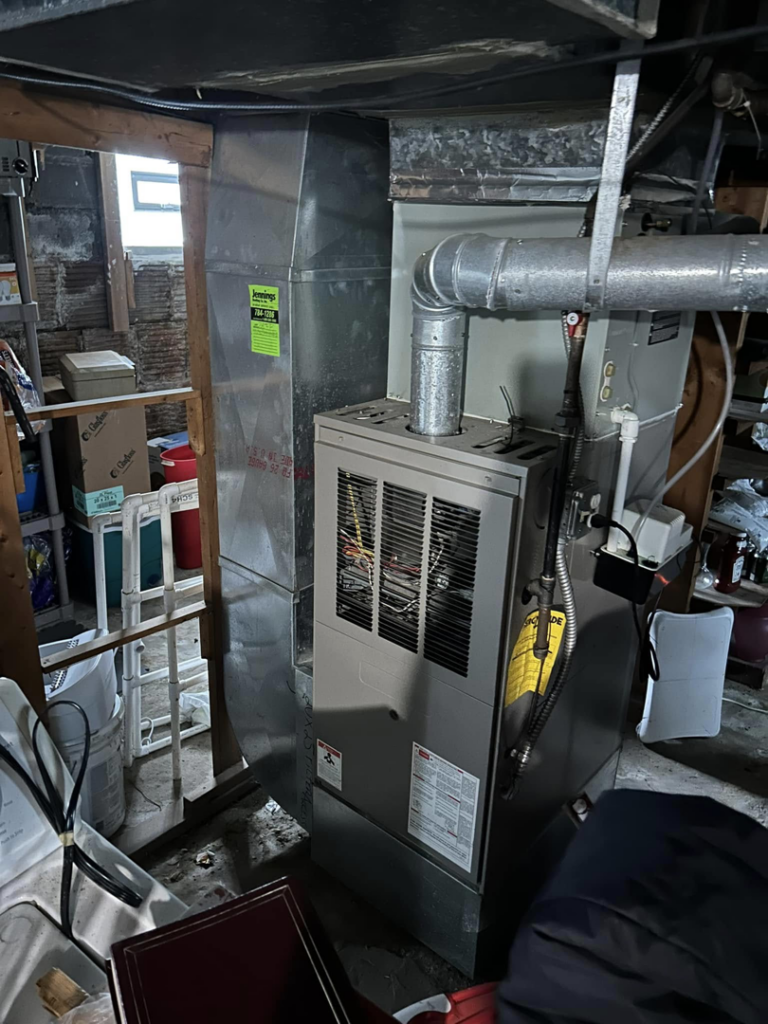 An indoor furnace and ductwork installation in a utility room by Handy Properties LLC in Akron, OH.