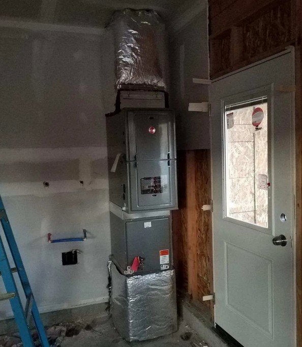 An indoor furnace and ductwork installation in a utility space, performed by Semenik Hvac/r in Spokane, WA.