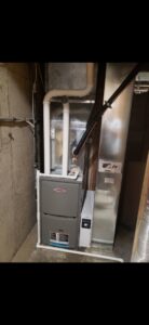 An indoor furnace and humidifier unit with ductwork installed by Preferred Heating & Air in Bismarck, ND.