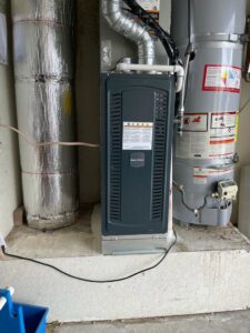 An indoor furnace unit installed next to a water heater by Affordable Heating and Air in Chatsworth, CA.