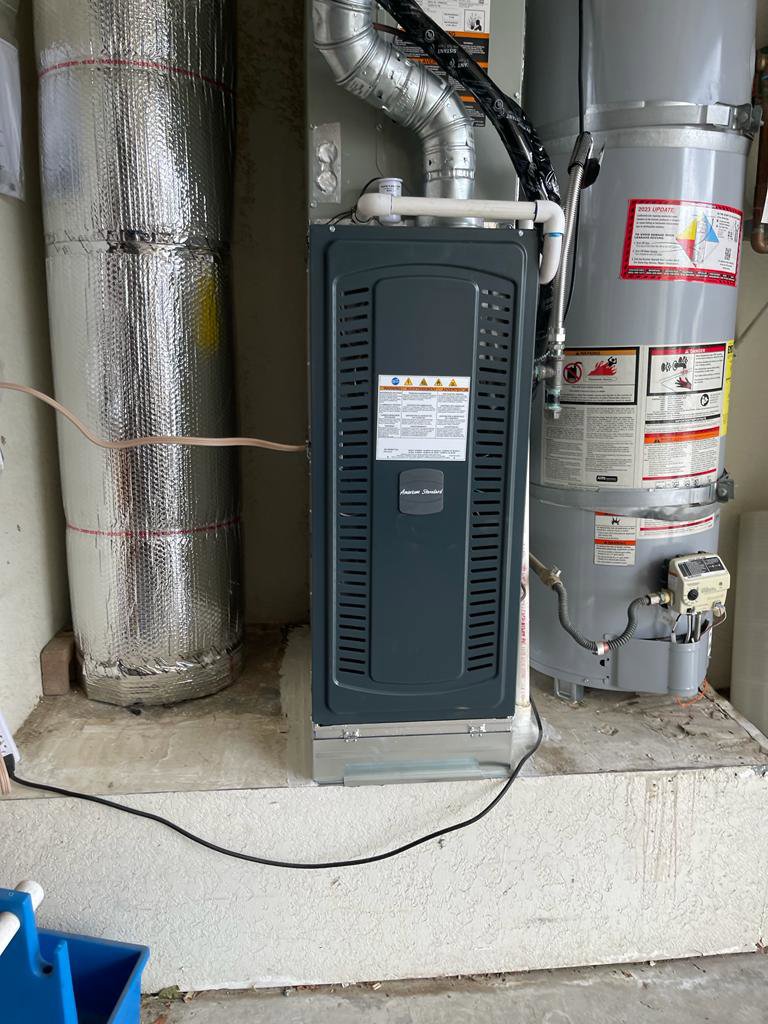 An indoor furnace unit installed next to a water heater by Affordable Heating and Air in Chatsworth, CA.