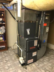 An indoor Goodman furnace and air handler unit installed by Detroit Metro Mechanical, Inc. in Harrison Township, MI.
