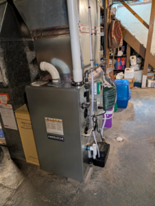 An indoor furnace and air handler unit with ductwork, installed by Hawn Heating and Air Conditioning in Rochester, NY.