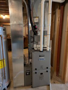 An indoor furnace and air handler unit installed by Mucciante Heating & Cooling, serving homes in Pekin, IL.