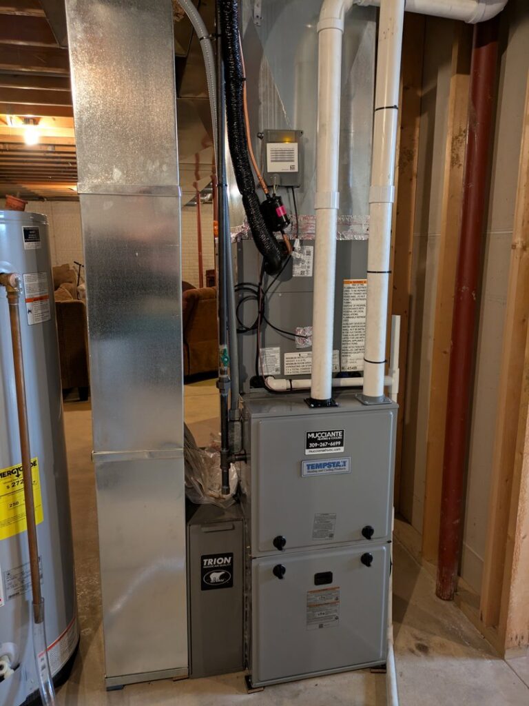 An indoor furnace and air handler unit installed by Mucciante Heating & Cooling, serving homes in Pekin, IL.