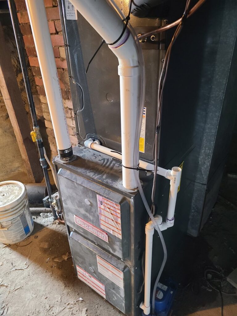 An indoor furnace installation with piping and connections by Rural Heating and Cooling Systems in Roundup, MT.