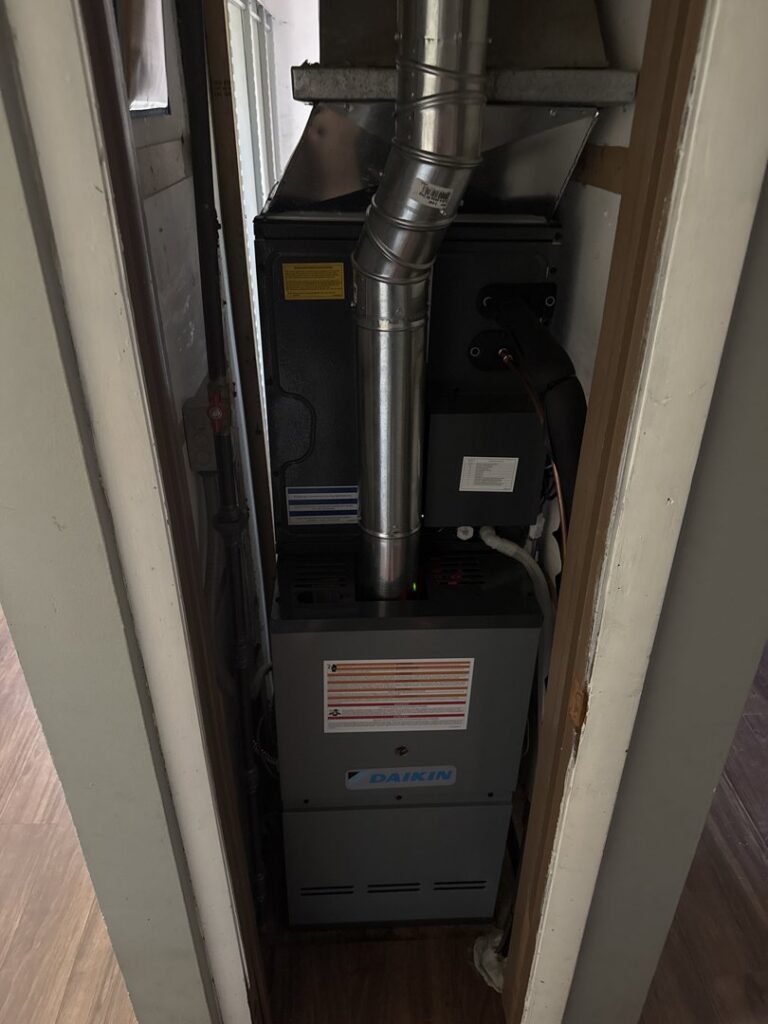 An indoor furnace unit installed in a utility closet by Swiss Air Heating & Cooling, providing heating solutions in O'Fallon, MO.