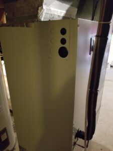Side view of an indoor furnace unit with new piping installed by Allwaysthere Heating and Cooling in Frederick, MD