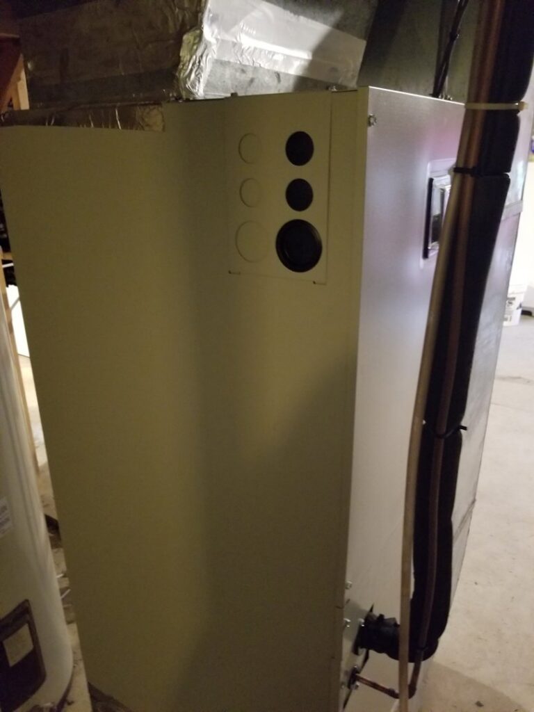 Side view of an indoor furnace unit with new piping installed by Allwaysthere Heating and Cooling in Frederick, MD
