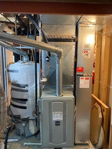 An indoor furnace and water heater installation by 365 Heating & Cooling in North Aurora, IL.