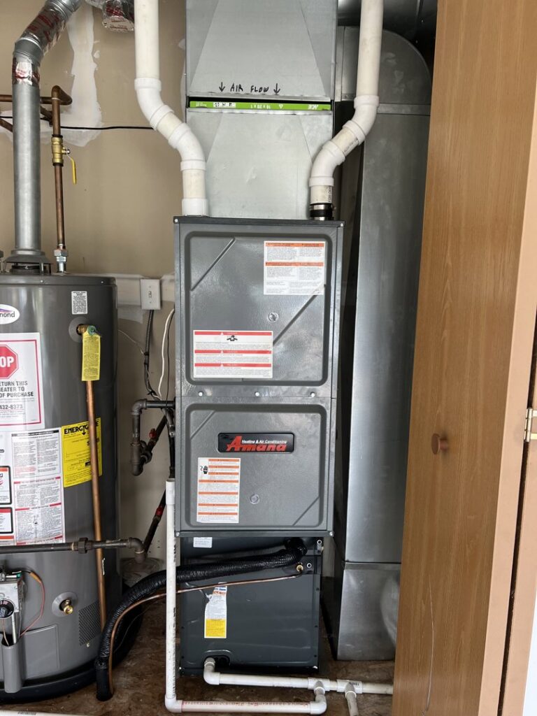 An indoor furnace and water heater installation by DJ's Heating & Air Conditioning in Wilmington, IL.