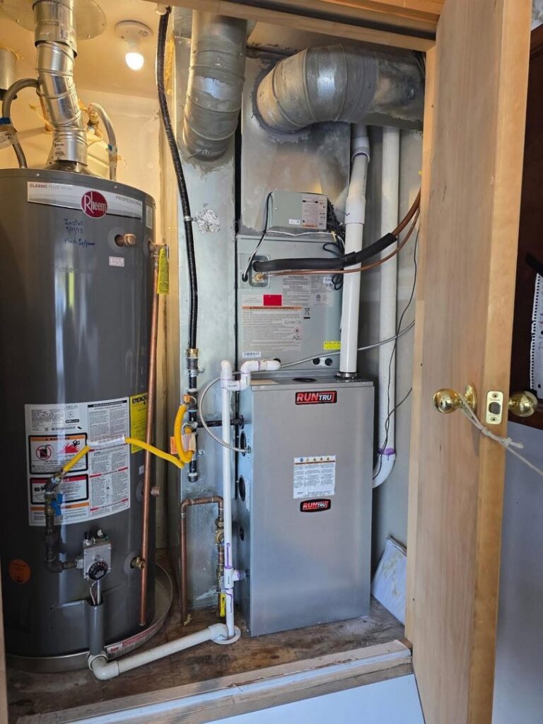 An indoor furnace and water heater installed in a utility closet by Lee's Heating & Cooling in Pueblo, CO.