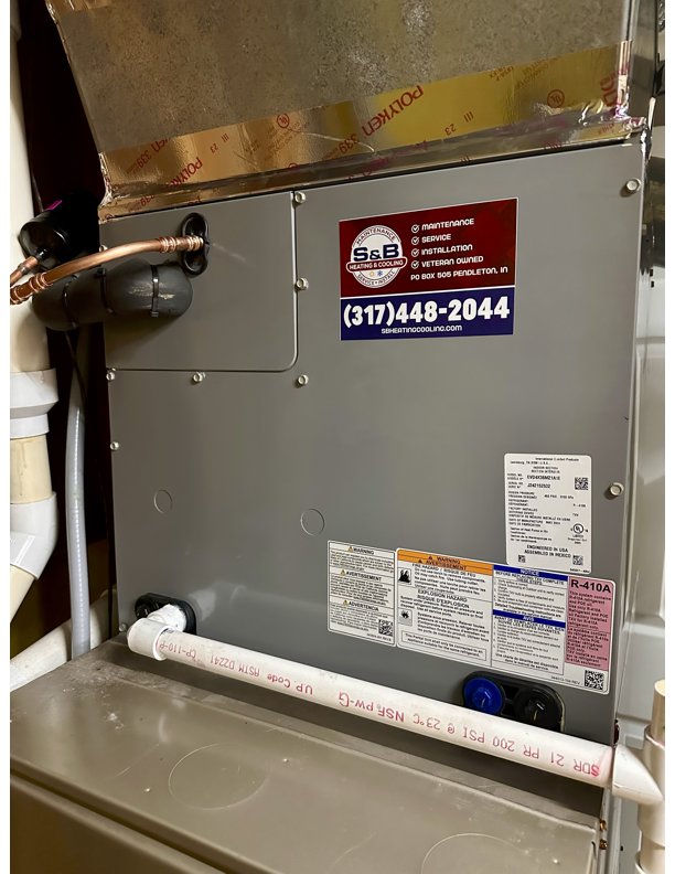 An indoor furnace unit with an S&B heating and cooling business sticker in Florence, KY.
