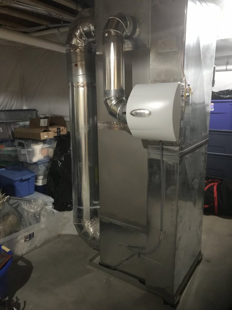 An indoor furnace and air handler unit with a whole-house humidifier attached, installed by Chad Byers - Edge Guys Heating & Cooling in Carmel, IN