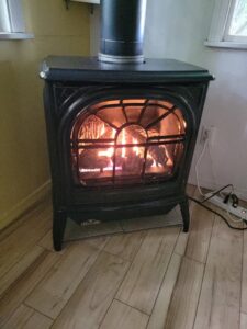 An indoor gas fireplace stove professionally installed in a home by Ryan's Heating & Air in Kalispell, MT.