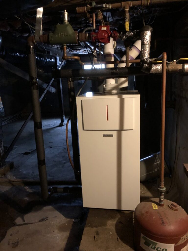 An indoor heating system, possibly a boiler or furnace, installed by Deon Arnold Heating & Air Conditioning in Fayetteville, NC