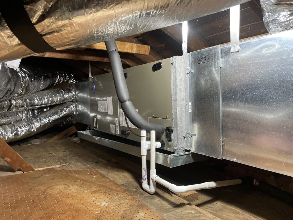 Indoor HVAC air handler unit installed in an attic with ductwork by Benavidez Heating & Air Conditioning In, Arlington, TX.