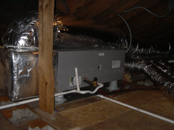 An indoor HVAC air handler unit and ductwork installed in an attic by Collis Mechanical Services in Norfolk, VA