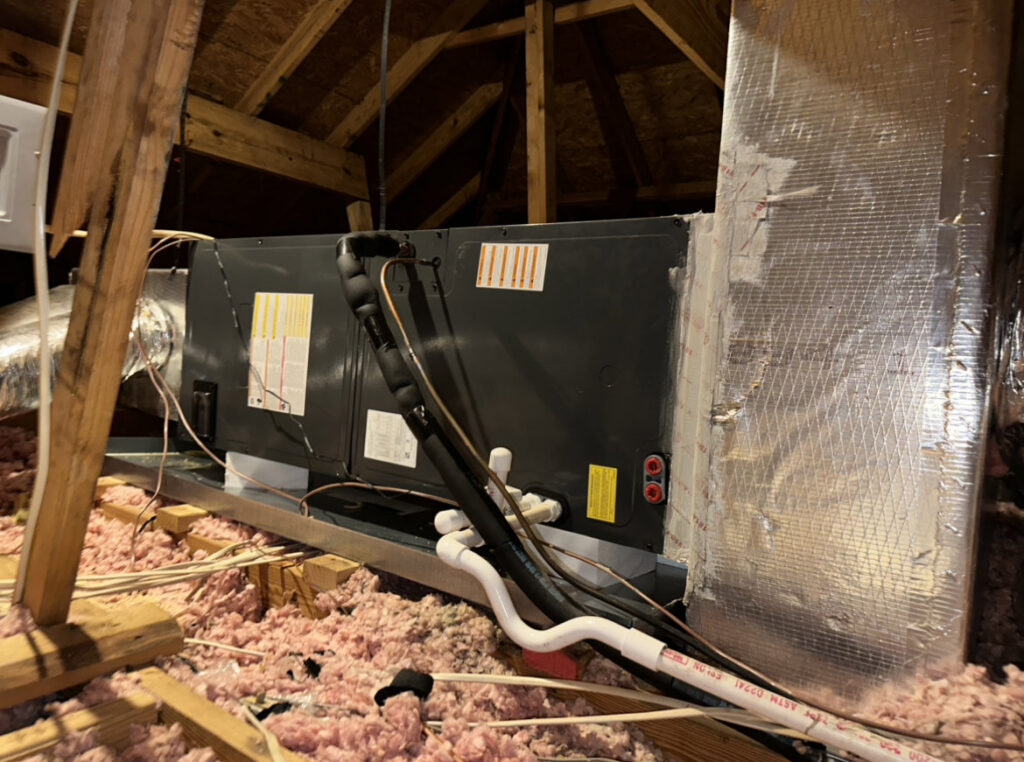An indoor HVAC air handler unit installed in an attic by Zippers Heating and Cooling in Mobile, AL.