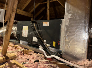 An indoor HVAC air handler unit installed in an attic by Zippers Heating and Cooling in Mobile, AL.
