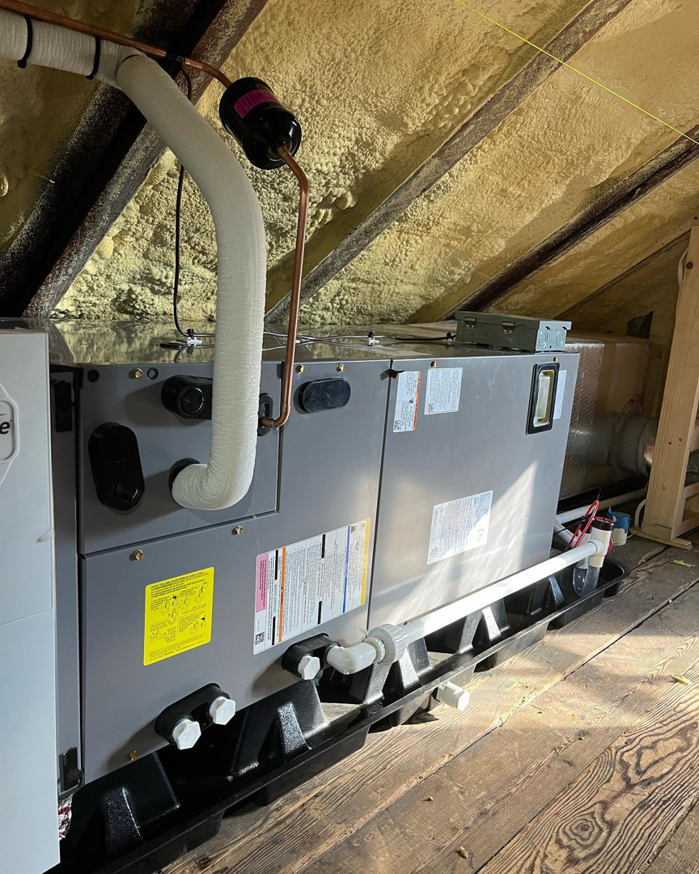 An indoor HVAC air handler unit installed in an attic space by Naugher Heating and Cooling in Lancaster, PA