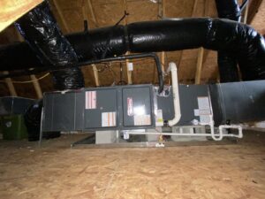 An indoor HVAC air handler unit with ductwork installed in an attic by Oakes AC Services, LLC in Louisburg, NC