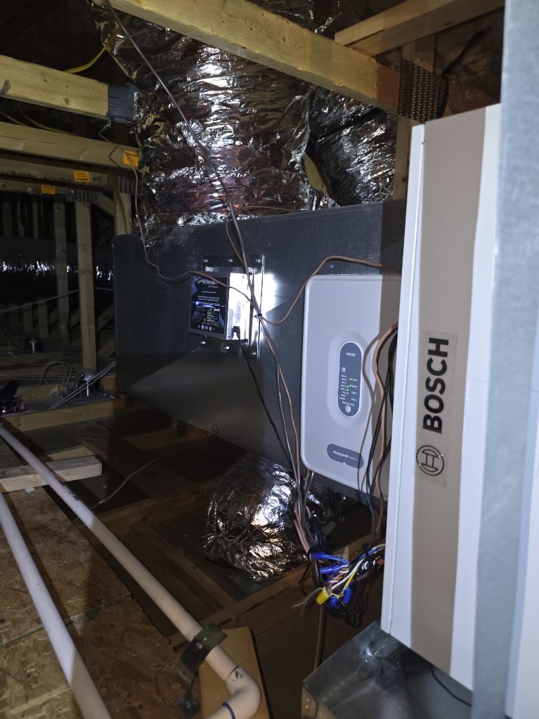 An indoor HVAC air handler unit with connected ductwork and a Bosch control unit installed in an attic by Krahn and Son Mechanical in Glendale, AZ.