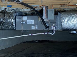 An indoor HVAC air handler unit installed in a crawl space by Subzero Mechanical LLC Heating & Air in Concord, NC.