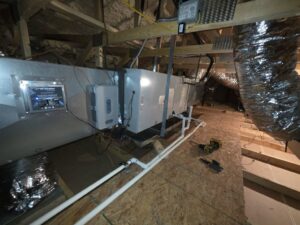 An indoor HVAC air handler unit with connected ductwork and an Air Scrubber device installed in an attic by Krahn and Son Mechanical in Glendale, AZ.