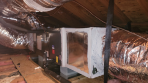 An indoor HVAC air handler unit and insulated ductwork installed in an attic by Efficiency HVAC in Milwaukie, OR.