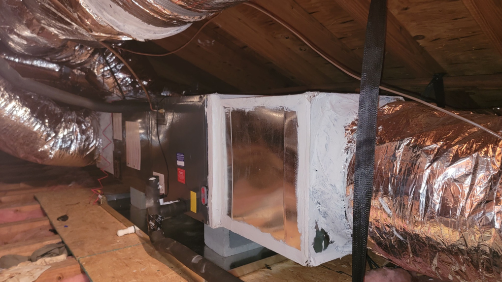 An indoor HVAC air handler unit and insulated ductwork installed in an attic by Efficiency HVAC in Milwaukie, OR.