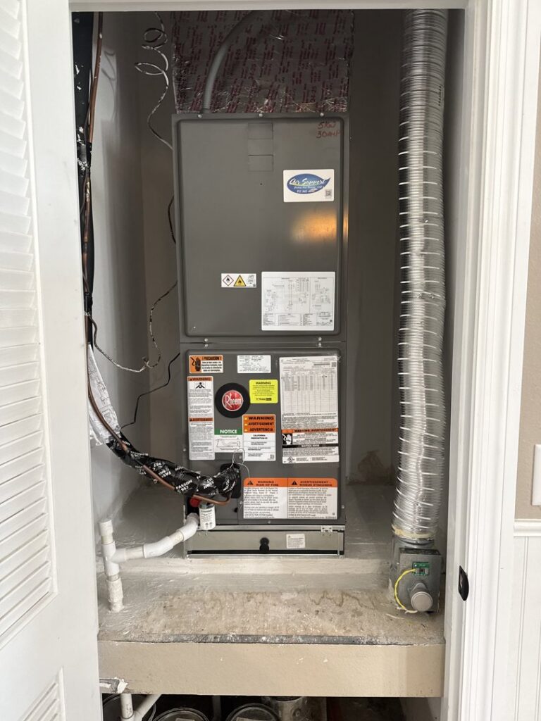 An indoor HVAC air handler unit installed in a utility closet by Air Support Cooling and Heating, LLC in Tampa, FL